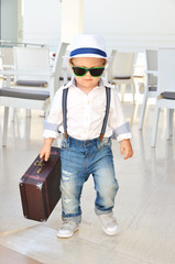 Baby traveler with a suitcase