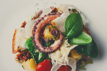 Salad with octopus and vegetables close up