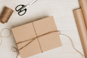 Cardboard carton wrapped with brown paper and tied with string