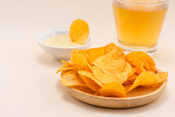 Cheese and onion potato chips with soft drink on table.