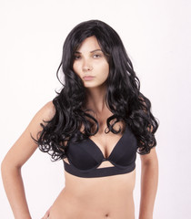 naked girl with long black hair in a black bra