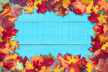 Blank rustic antique teal blue wood sign with colorful autumn leaves border