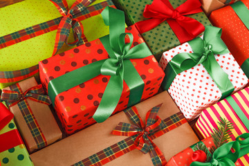 Fototapeta na wymiar Lots of xmas gift boxes. Stylish modern presents in colored paper. Crop, close up