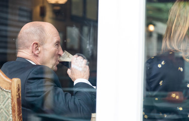 Senior man with friends in pub drink porter type beer
