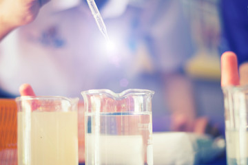 Students are mixing chemicals learning in science in class.