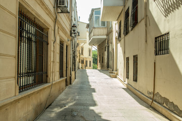 Fototapeta na wymiar Narrow old classic empty street in Old City of Baku - Icheri Sheher.