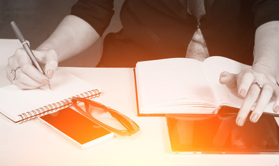 woman in business clothes writes in the notebook,