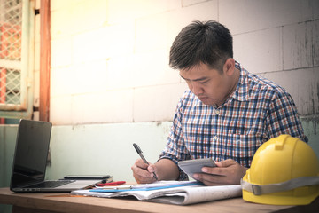 Engineer manager working document about progress of work schedule on the construction job site