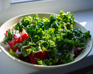 Prepared salad in the hand in the countryside.