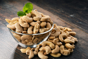 Bowl with cashew nuts on wooden table