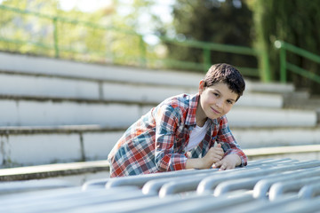 portrait of a casual teen boy, outdoors