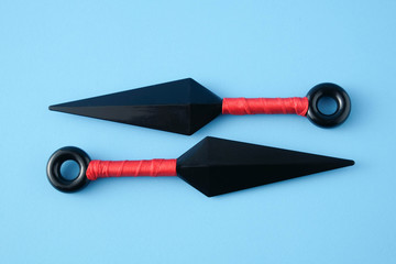 To throw ninja weapons isolated on blue paper background © Nattapol_Sritongcom