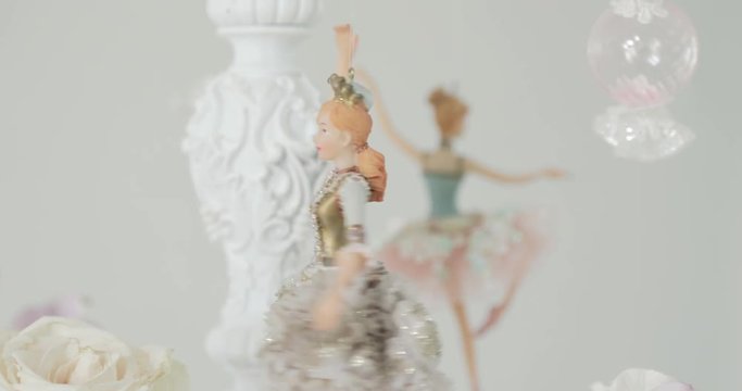 silhouette of ballerina toy in classical tutu in the white studio
