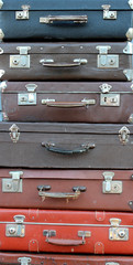 Old vintage suitcases lie one on the other and are sold on the flea market. Old suitcases for long...