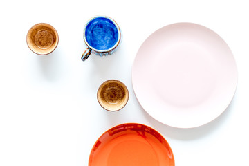 Crockery. Empty cups and plates on white background top view copyspace mockup