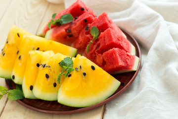 Yellow watermelon sliced on wooden background