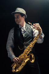 Fototapeta na wymiar Young man playing the Saxophone