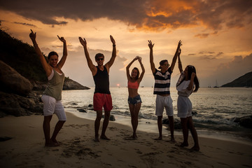 Friends on beach at sunset