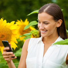 Close-up portrait of beautiful joyful woman with sunflower