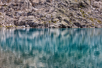 reflections of the rocks on the high mountain lake