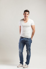 studio shot of young man in jeans and t-shirt