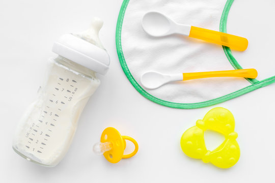 Mother care breast milk in bottle and infant formula powdered healthy food for baby feeding on white background top view