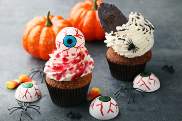 Halloween cupcakes on grey wooden table