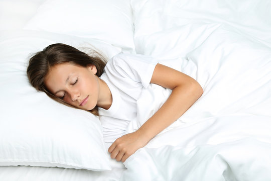 Beautiful girl sleeping in white bed