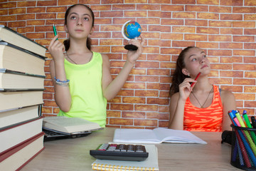 Young Girls studying on desk at home. Thoughts, education, creativity concept