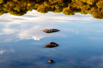 Reflection of a few rocks in the dried out lake Padulu Tortu on the island of Corsica.