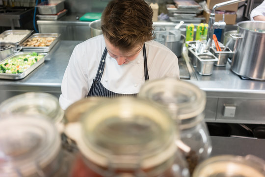 High-angle view of a young skilled man working as chef in a commercial kitchen