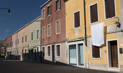 Fototapeta na wymiar A street with different-coloured houses in Murano, Italy