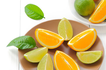 Orange slices with leaves on white