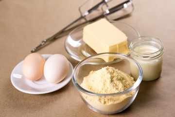 Fototapeta na wymiar Ingredients for the preparation of corn biscuits, corn flour, egg, butter, condensed milk