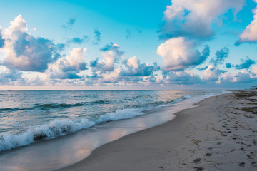 white clouds and blue sky over the ocean on a summer morning at the beach