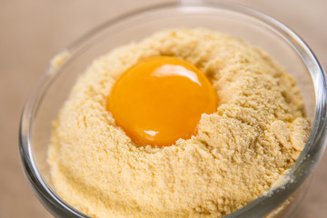 egg yolk lies in yellow corn flour