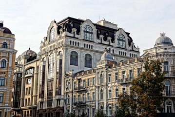 Fototapeta na wymiar серо коричневый фасад многоэтажного здания с балконами и окнами на фоне неба