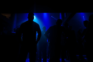 Silhouettes of people in a disco