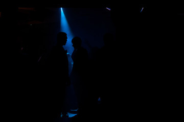 Silhouettes of people in a disco