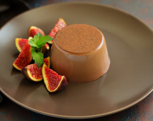Delicious home-made chocolate dessert Panna cotta. Cream-caramel, caramel custard, with figs.