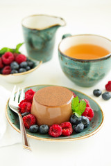 Delicious home-made chocolate dessert Panna cotta. Cream-caramel, caramel custard, with raspberries and blueberries.
