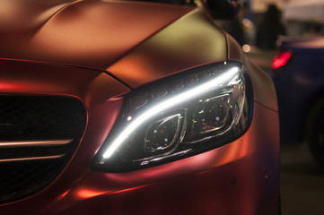 Headlight of a sports car, closeup.