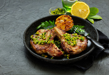 Pork cutlet on a bone with gremolat sauce.