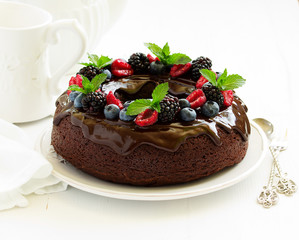 Chocolate cake with glaze and fresh berries