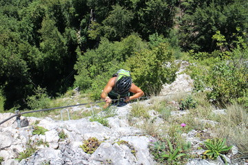 Woman climber in via ferrata Trattenbacher Klettersteig - Beisteinmauer, Austria 