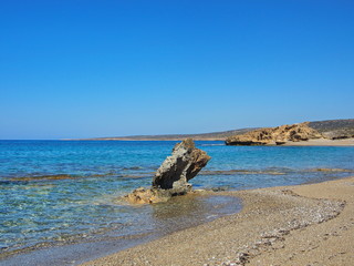 single rock surrounded by water 