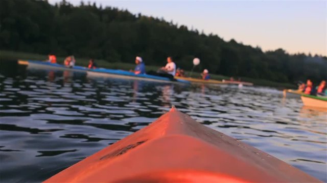 People in kayaking on Lake at sunset