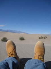 landscape of death valley with boots in the sand