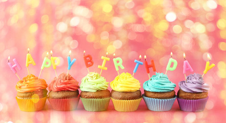 Happy birthday cupcakes on pink background
