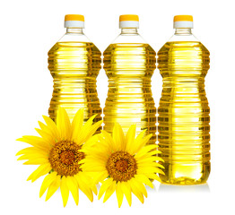 Bottles of cooking oil with sunflowers on white background